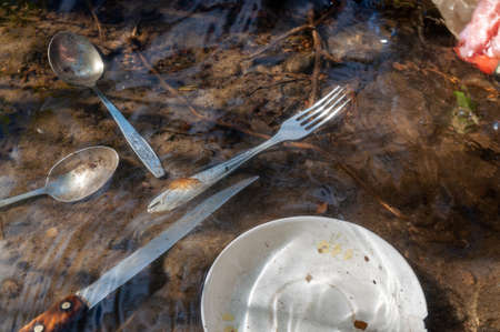 washing dirty dishes in the lake. environmental problems. water supply problem in the village
