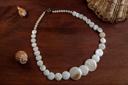 natural mother-of-pearl necklace on a wooden background