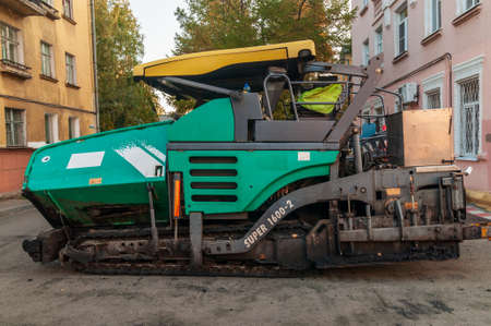 asphalt paver on city streetのeditorial素材