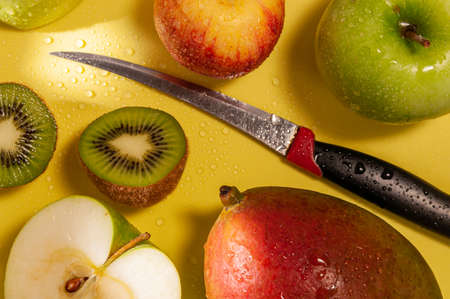 fresh fruit on a yellow background covered with water drops. High quality photo