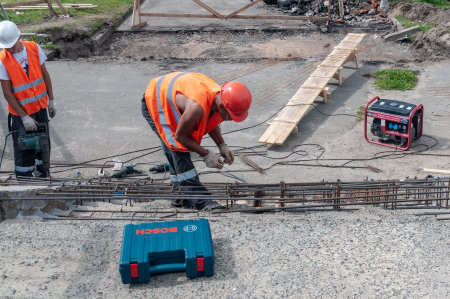workers in orange vests repair the concrete stairsのeditorial素材