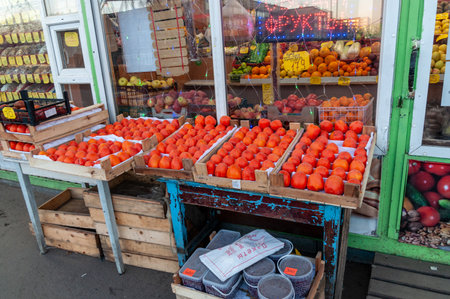 Petrozavodsk, Russia - 10 December 2020. vegetable shop counter with bright ripe persimmonのeditorial素材
