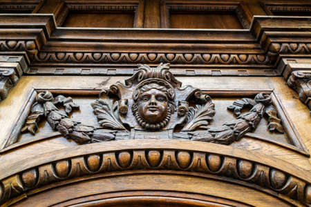 elaborate wood carvings adorn the massive wooden doorのeditorial素材