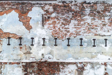 texture of an old brick wall with partially collapsed plaster. High quality photoの写真素材