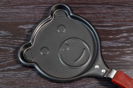 Funny pan for pancakes. A frying pan with a bear face.の写真素材