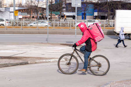 food deliveryman on a bicycle. Motion blurのeditorial素材