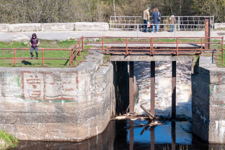 Petrozavodsk, Russia - 19 May 2019. Young man sits on the edge of the parapet bridge
