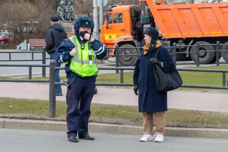 Petrozavodsk, Russia - 1 May 2021. Traffic police officer talks to elderly woman