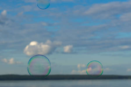 soap bubbles against the sky with cloudsの写真素材
