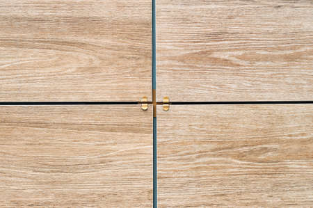 Facing tiles with a wood texture on the facade of the building