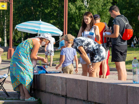 street trading. a group of people near a woman selling handmade jewelryのeditorial素材