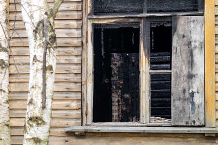broken windows in an old abandoned wooden house. renovation. resettlement of emergency housing. High...