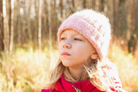 portrait of an eight-year-old girl in an autumn park on a sunny day. High quality photo