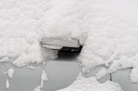 car door handle covered with snowの写真素材