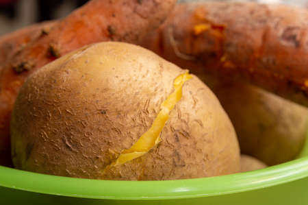 Boiled potatoes and carrots with peelの写真素材