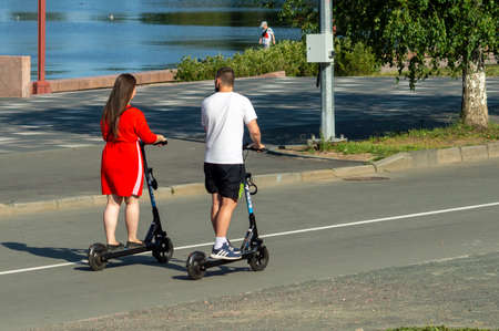 young couple on electric scootersのeditorial素材