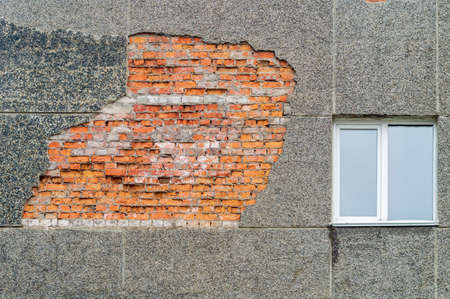 Facade of the building with collapsed plaster