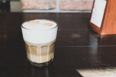 latte on the table in a transparent glassの写真素材