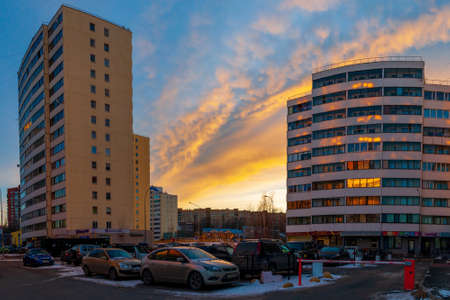 Petrozavodsk, Russia - 15 March 2020. multi-storey apartment buildings and parked cars at sunset