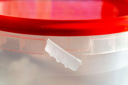 close-up of empty round plastic container with lid. opened container