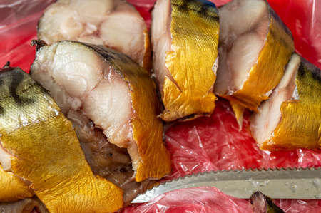 smoked mackerel cut into pieces. selective focus
