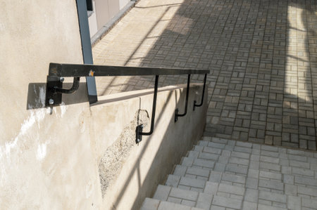 black metal handrail at the concrete staircase. selective focus