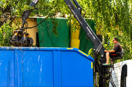 Petrozavodsk, Russia - 1 July 2022. cleaning of construction debris with a manipulator