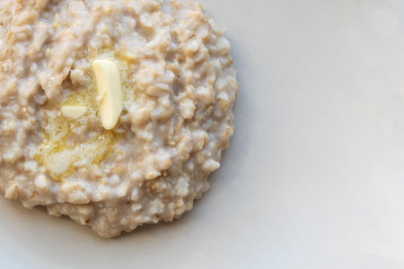 oatmeal porridge with butter on a plateの写真素材