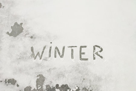 Snow-covered background with the word winterの写真素材