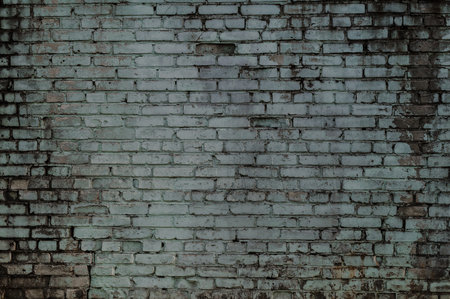 Dark texture of old dirty and cracked brick wallの写真素材