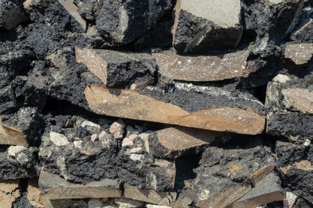 Texture of asphalt pavement fragments stacked on top of each other. Fragments of asphalt from road...