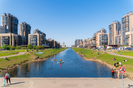 Saint Petersburg, Russia - 21 May 2023. People relax on the banks of the canal and ride SUP-boards. urban landscapeのeditorial素材