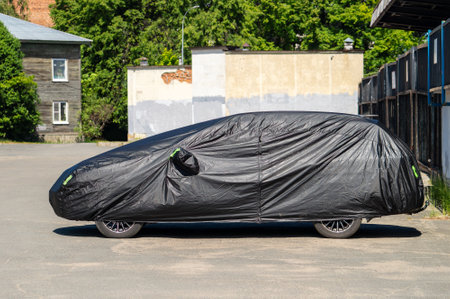 A car covered with a black coverの写真素材