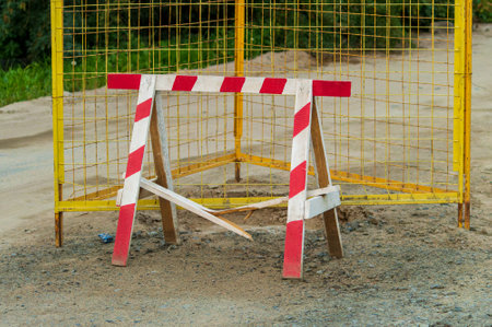Fence near pothole on road
