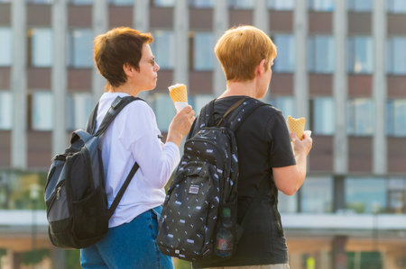 Petrozavodsk, Russia - 1 September 2023. Two mature women eat ice cream while walking down the streetのeditorial素材