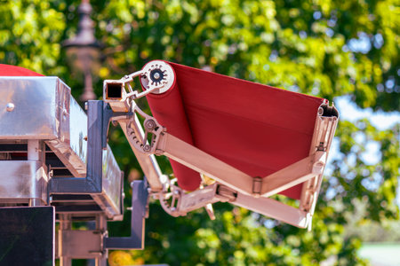Mechanical arm extends a fabric awning, highlighting functional design for sun protection and alfresco service. The image conveys summertime leisure, commercial hospitality, and urban comfort solutions.