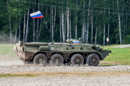 fast-moving armored vehicle on a stony road