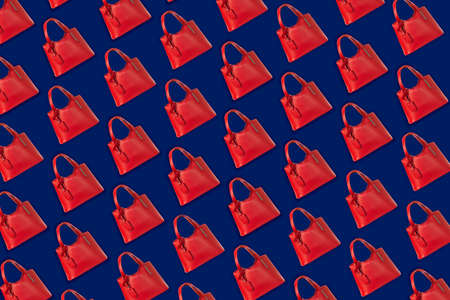 Seamless texture of red female handbag on a blue backgroundの写真素材