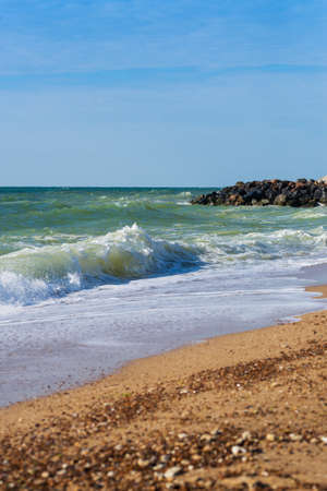 Waves in the ocean and sand on the beach, blue sky sunny dayの写真素材