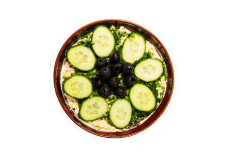 Vegetable salad in clay plate isolated on white with top viewの写真素材