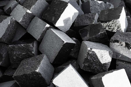 Cut squares of black marble piled up and ready for footpaths and pavements