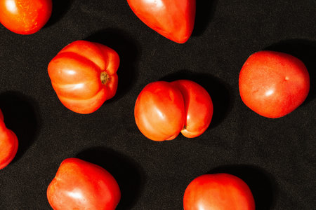 Seamless pattern with tomatoes. Abstract background. Tomato on the black background.の写真素材