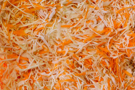 Vegetable salad. Shredded cabbage and carrots close-up background. Abstract background of chopped carrots and white cabbage,の写真素材