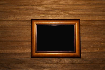 Wooden frame for photo and design on a wooden surface