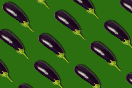 Seamless pattern with fresh eggplants on a green background. Seamless pattern. Eggplant seamless pattern. Health food. Eggplant is a vegetarian product.の写真素材
