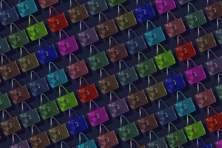 Seamless texture of women's handbags in different colors with a shadow on a blue background. Seamless background from the collection of women's accessories.の写真素材