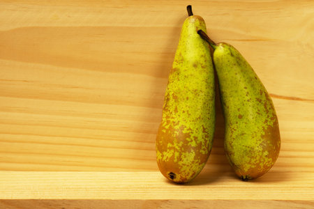 Two pears on a plank wooden light backgroundの写真素材