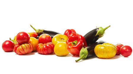 Freshly picked set of red and yellow tomatoes with eggplant, onion and red pepper isolated on white background.の写真素材