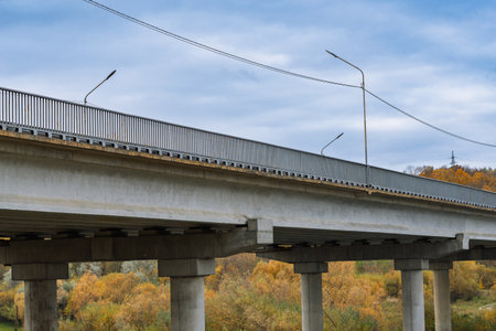 Automobile bridge across the river in autumn.の写真素材