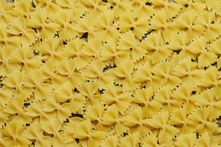 Texture of macaroni bows on granite kitchen surface.の写真素材